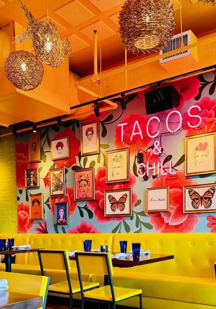 Tacos & chill pink neon sign restaurant interior