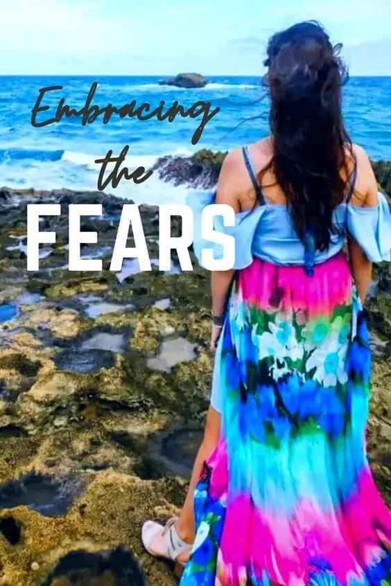 Embracing the fears girl facing ocean