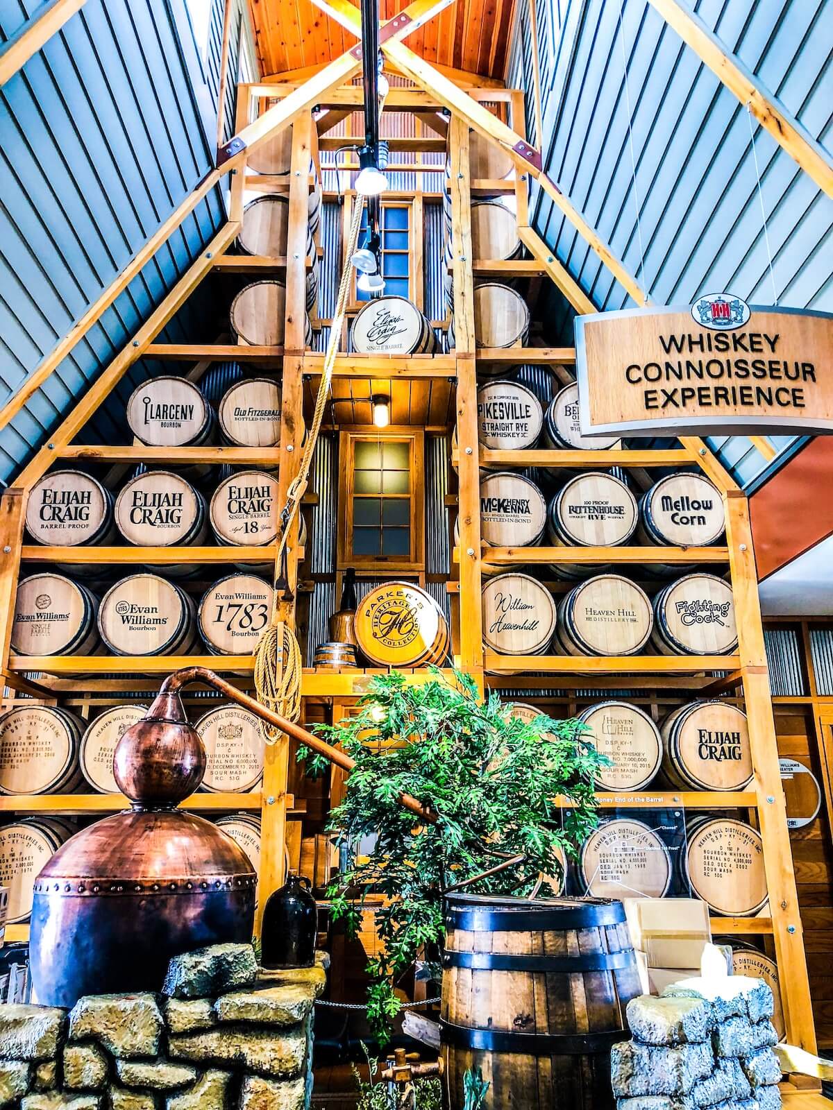 Wall of bourbon barrels on shelves at heaven hill distillery visitor center